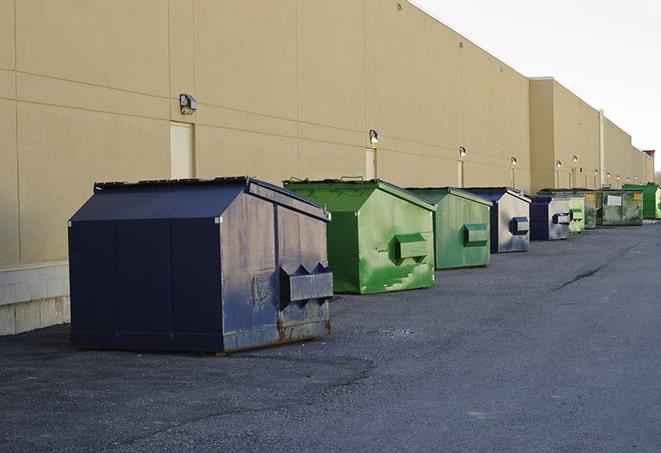 construction workers disposing of debris in large dumpsters in Berkley